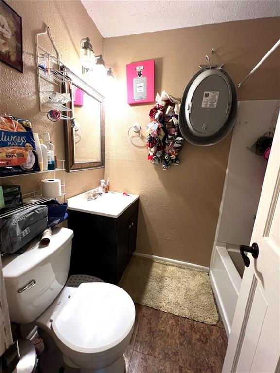 4325 Loire Dr, Kenner, LA 70065 - bathroom featuring vanity, a textured ceiling, and washtub / shower combination