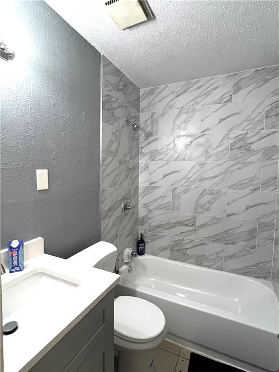 4325 Loire Dr, Kenner, LA 70065 - bathroom featuring a textured ceiling,  shower combination, and vanity