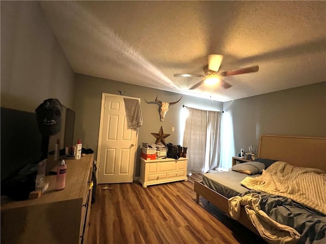 4325 Loire Dr, Kenner, LA 70065 - bedroom featuring a textured ceiling, dark wood-style floors, and ceiling fan