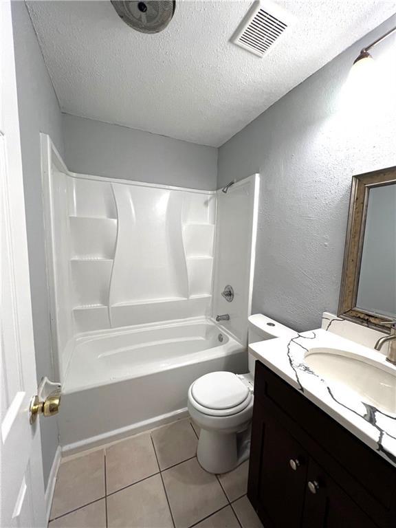 4325 Loire Dr, Kenner, LA 70065 - full bathroom with vanity, a textured ceiling, shower / bathtub combination, tile patterned flooring, and a textured wall