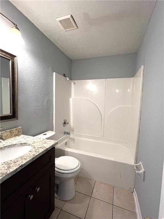 4325 Loire Dr, Kenner, LA 70065 - full bath featuring vanity, a textured ceiling, tile patterned flooring, and shower / bathtub combination