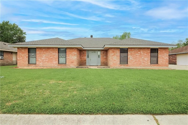 2137 Carmel Valley Dr, La Place, LA 70068 - ranch-style home with a front lawn, brick siding, and a shingled roof