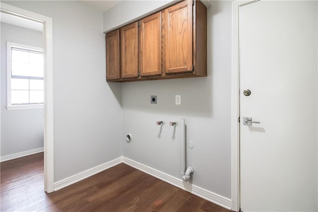2137 Carmel Valley Dr, La Place, LA 70068 - laundry room featuring electric dryer hookup, cabinet space, dark wood finished floors, hookup for a washing machine, and gas dryer hookup