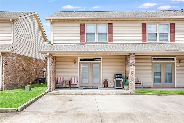 1404 Windsor St Unit 1A, La Place, LA 70068 - rear view of house featuring french doors, covered porch, and roof with shingles