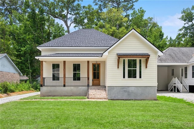 1023 W 19th Ave, Covington, LA 70433 - view of front of home featuring covered porch, a shingled roof, a front lawn, and gravel driveway