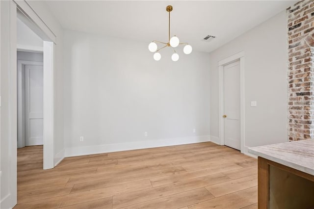 1023 W 19th Ave, Covington, LA 70433 - unfurnished dining area with a chandelier and light wood finished floors
