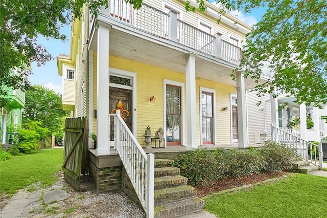 252224 General Pershing St, New Orleans, LA 70115 - view of front of house featuring a porch, a balcony, and a front yard