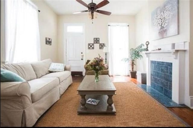 252224 General Pershing St, New Orleans, LA 70115 - living area featuring ceiling fan, a fireplace, and wood finished floors