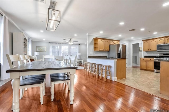 432 Emerald St, New Orleans, LA 70124 - dining room featuring ceiling fan, crown molding, recessed lighting, and light wood finished floors