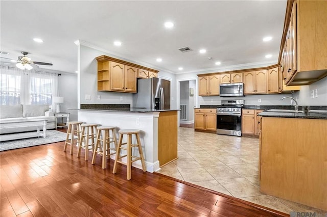 432 Emerald St, New Orleans, LA 70124 - kitchen featuring appliances with stainless steel finishes, crown molding, open shelves, a peninsula, and ceiling fan