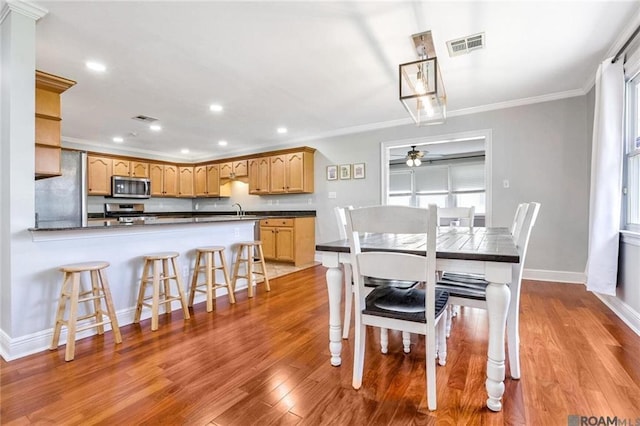 432 Emerald St, New Orleans, LA 70124 - dining area featuring a ceiling fan, wood finished floors, crown molding, recessed lighting, and plenty of natural light