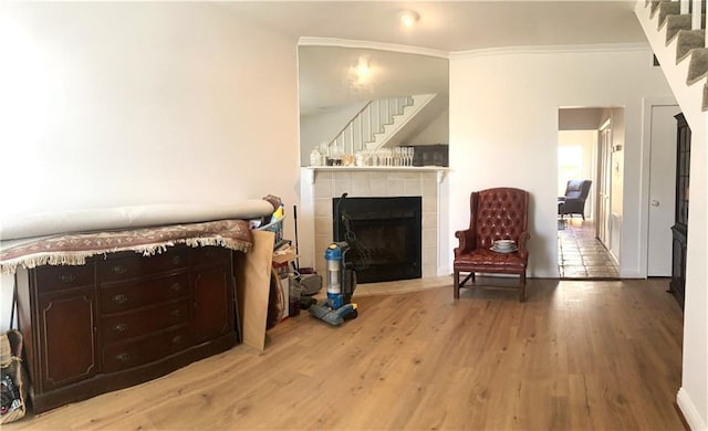 704 General Pershing St Unit 704, New Orleans, LA 70115 - sitting room featuring wood finished floors, a fireplace, crown molding, and stairway