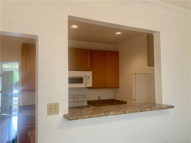 704 General Pershing St Unit 704, New Orleans, LA 70115 - kitchen with white appliances, brown cabinets, and recessed lighting