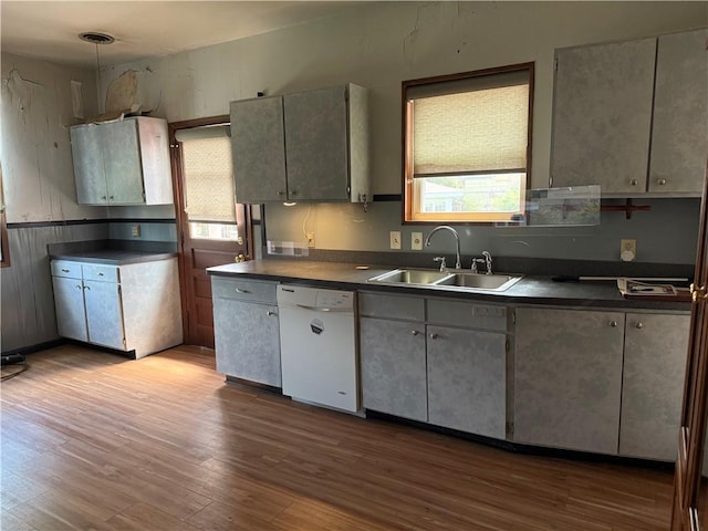 490 Lions St, Jefferson, LA 70121 - kitchen featuring white dishwasher, dark countertops, and dark wood finished floors
