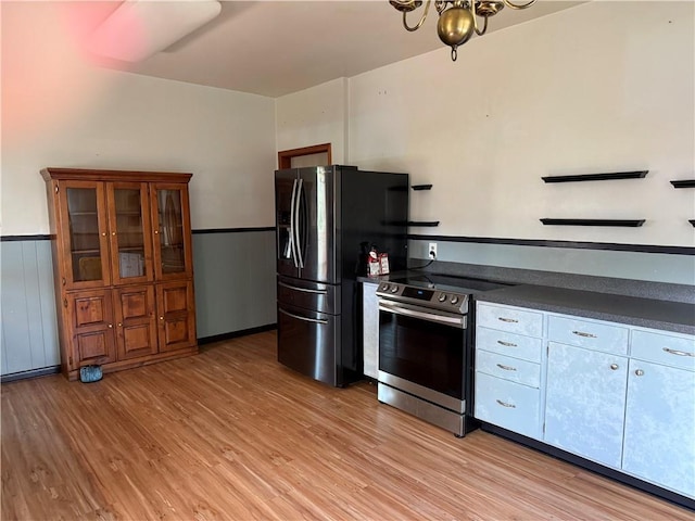 490 Lions St, Jefferson, LA 70121 - kitchen featuring stainless steel electric stove, dark countertops, light wood-style floors, fridge with ice dispenser, and a chandelier