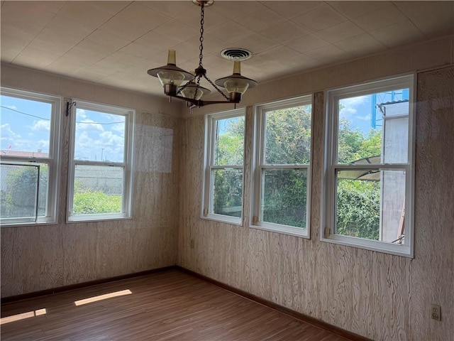 490 Lions St, Jefferson, LA 70121 - empty room featuring plenty of natural light, wood finished floors, and a chandelier