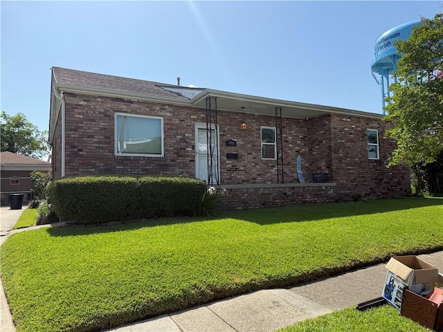 490 Lions St, Jefferson, LA 70121 - ranch-style house with a front yard and brick siding