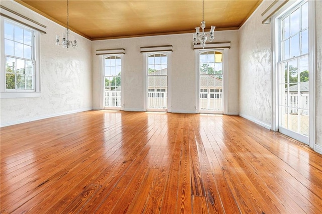 349 Vallette St, New Orleans, LA 70114 - unfurnished room featuring a chandelier, wood-type flooring, healthy amount of natural light, crown molding, and a textured wall