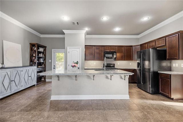 42467 Harlan Pl, Ponchatoula, LA 70454 - kitchen featuring black microwave, refrigerator with ice dispenser, ornamental molding, a breakfast bar, and tasteful backsplash
