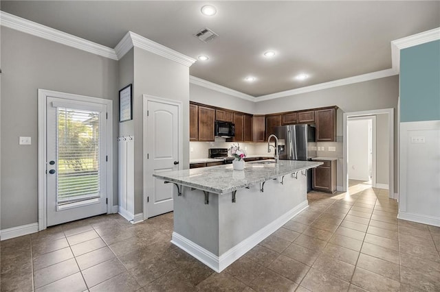 42467 Harlan Pl, Ponchatoula, LA 70454 - kitchen featuring black microwave, stainless steel refrigerator with ice dispenser, crown molding, stove, and light stone counters