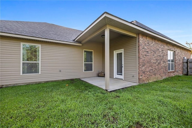 42467 Harlan Pl, Ponchatoula, LA 70454 - back of property featuring a patio area, a yard, brick siding, and a shingled roof