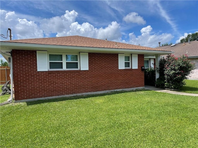 2305 26th St, Kenner, LA 70062 - view of side of home featuring a yard, brick siding, and roof with shingles