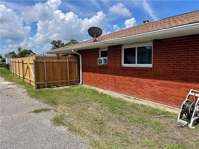 2305 26th St, Kenner, LA 70062 - view of side of home featuring brick siding, cooling unit, and roof with shingles