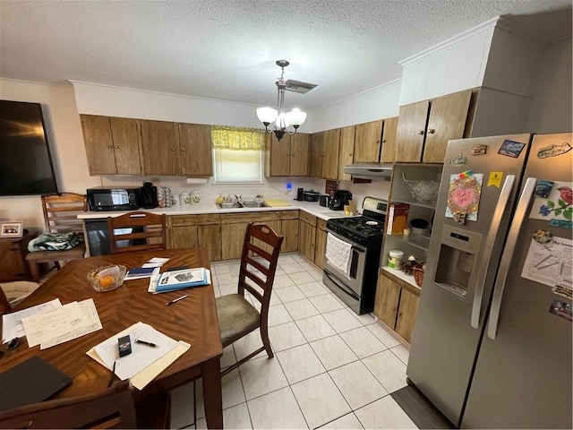 2305 26th St, Kenner, LA 70062 - kitchen with appliances with stainless steel finishes, range hood, light countertops, pendant lighting, and a chandelier