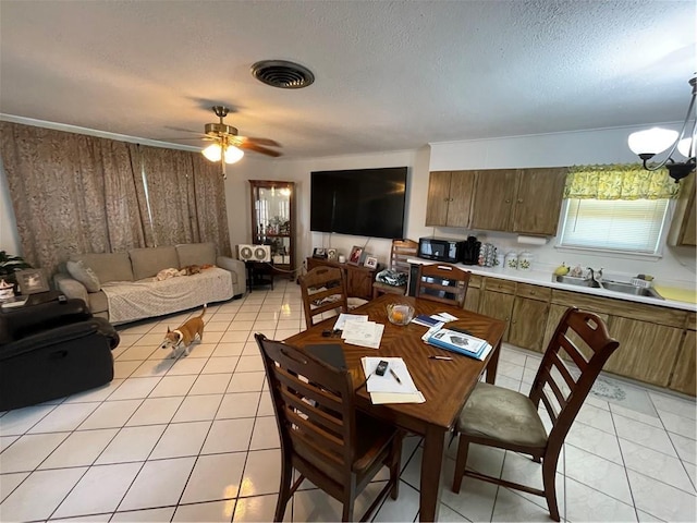 2305 26th St, Kenner, LA 70062 - dining area with light tile patterned floors, a ceiling fan, a textured ceiling, and a chandelier
