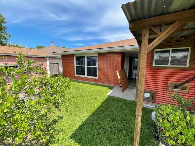 2305 26th St, Kenner, LA 70062 - rear view of house with brick siding, a patio, and roof with shingles