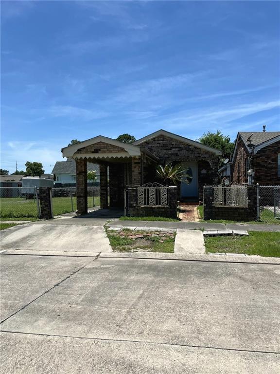 1615 Pratt St, Gretna, LA 70053 - view of front of home with driveway, a carport, and a gate