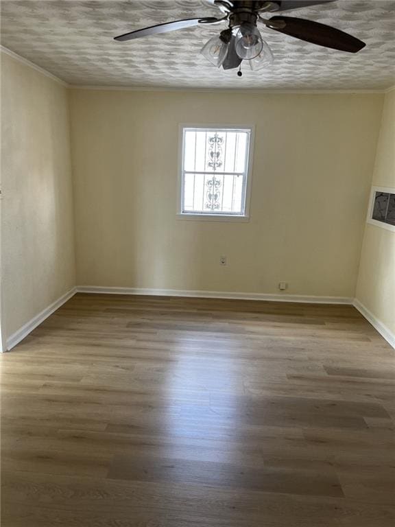 1615 Pratt St, Gretna, LA 70053 - unfurnished room featuring a ceiling fan, wood finished floors, and crown molding