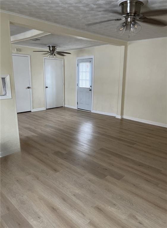 1615 Pratt St, Gretna, LA 70053 - unfurnished room featuring a ceiling fan, wood finished floors, beam ceiling, and a textured ceiling