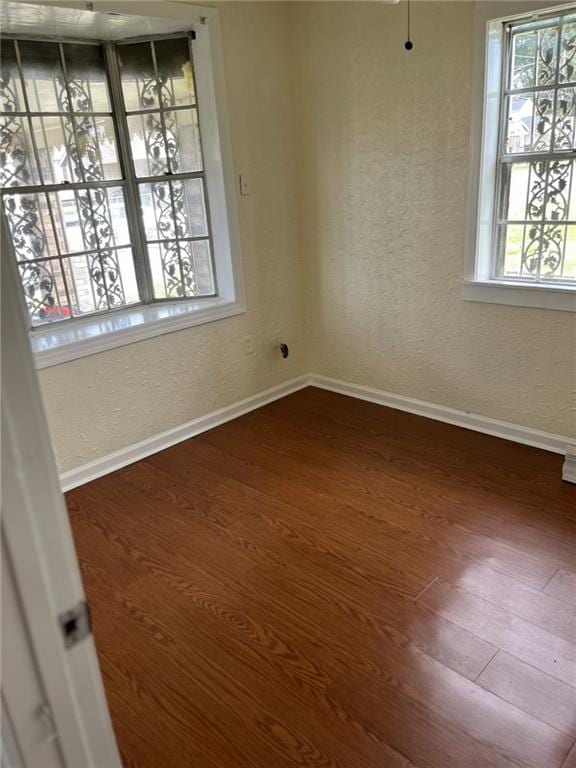 1615 Pratt St, Gretna, LA 70053 - empty room with wood finished floors and a textured wall