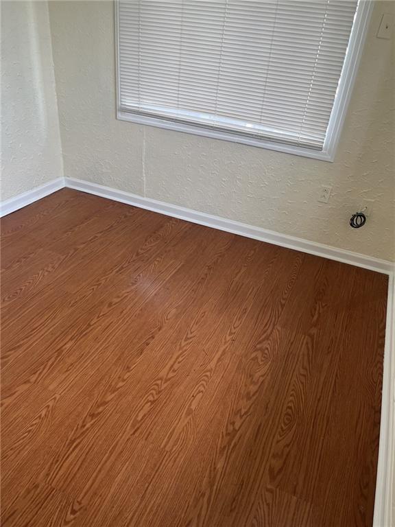 1615 Pratt St, Gretna, LA 70053 - unfurnished room featuring dark wood-type flooring and baseboards