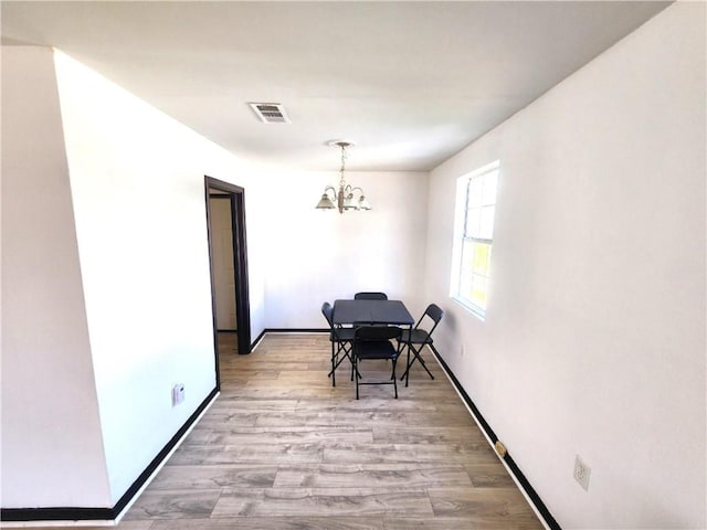 106 Treuil Ln, Belle Chasse, LA 70037 - dining room with a chandelier and light wood-type flooring