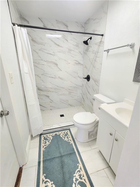 106 Treuil Ln, Belle Chasse, LA 70037 - bathroom featuring vanity, a stall shower, and marble finish flooring
