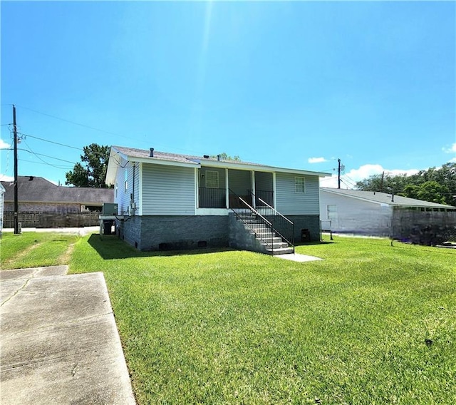 106 Treuil Ln, Belle Chasse, LA 70037 - rear view of property featuring a lawn
