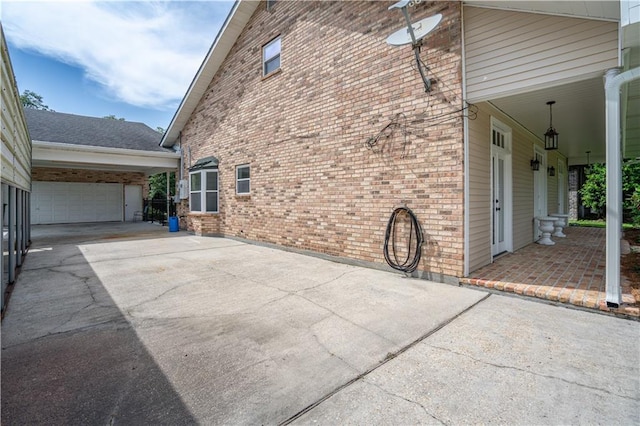 119 Gondrella Dr, Belle Chasse, LA 70037 - view of home's exterior with driveway, an attached garage, and brick siding