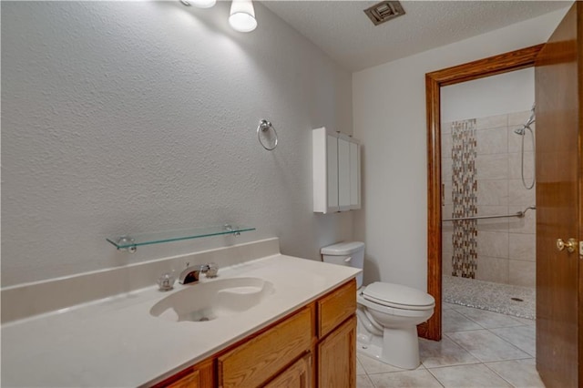 119 Gondrella Dr, Belle Chasse, LA 70037 - full bath with a tile shower, vanity, tile patterned flooring, a textured ceiling, and a textured wall