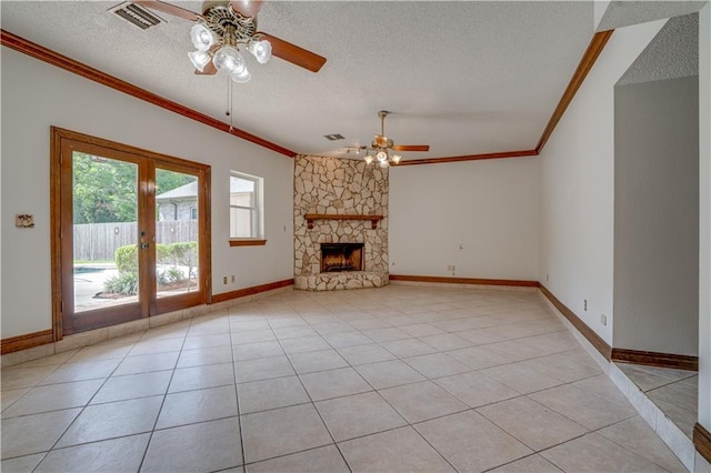 119 Gondrella Dr, Belle Chasse, LA 70037 - unfurnished living room featuring a ceiling fan, ornamental molding, a textured ceiling, a stone fireplace, and french doors
