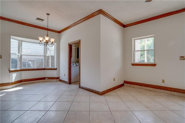 119 Gondrella Dr, Belle Chasse, LA 70037 - unfurnished room with separate washer and dryer, a chandelier, a textured ceiling, crown molding, and light tile patterned floors