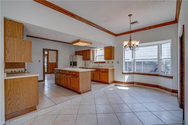 119 Gondrella Dr, Belle Chasse, LA 70037 - kitchen featuring white refrigerator with ice dispenser, a chandelier, light tile patterned flooring, a textured ceiling, and black electric cooktop