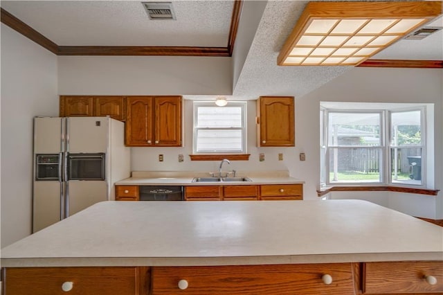119 Gondrella Dr, Belle Chasse, LA 70037 - kitchen with white fridge with ice dispenser, crown molding, brown cabinetry, dishwasher, and light countertops