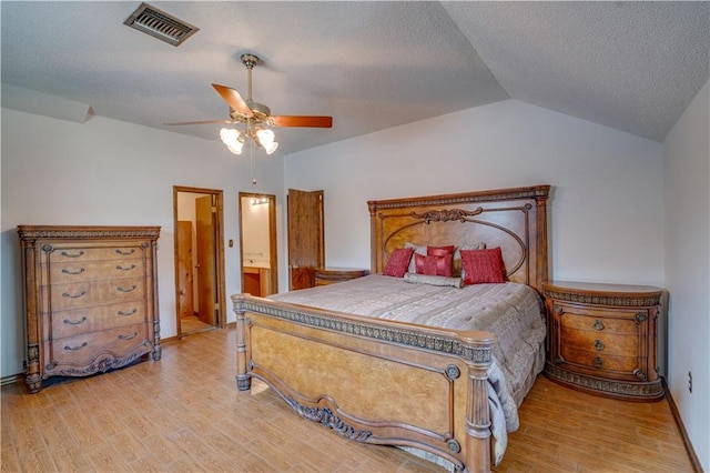 119 Gondrella Dr, Belle Chasse, LA 70037 - bedroom with light wood-type flooring, lofted ceiling, a textured ceiling, ensuite bathroom, and a ceiling fan