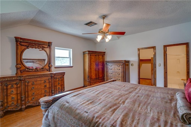119 Gondrella Dr, Belle Chasse, LA 70037 - bedroom with wood finished floors, ceiling fan, a textured ceiling, lofted ceiling, and connected bathroom