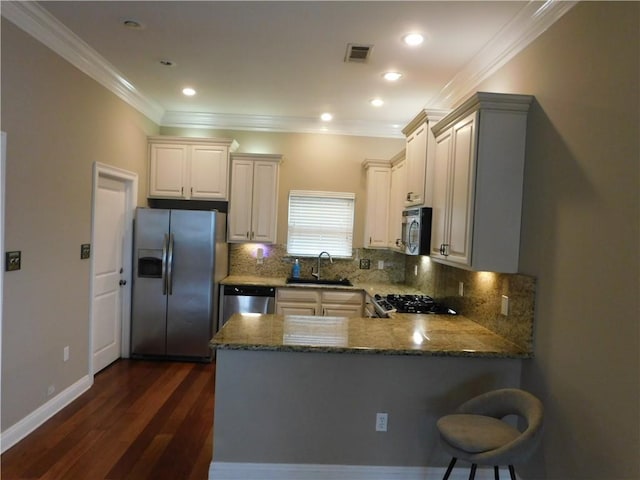 22 Davis Blvd, Jefferson, LA 70121 - kitchen with stainless steel appliances, stone countertops, a peninsula, tasteful backsplash, and dark wood-type flooring