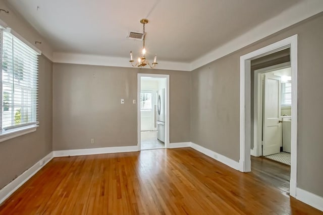 157 Gruner Rd, Metairie, LA 70001 - unfurnished dining area with plenty of natural light, wood finished floors, and a chandelier