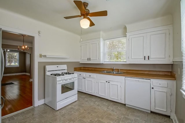 157 Gruner Rd, Metairie, LA 70001 - kitchen featuring white appliances, white cabinets, a chandelier, and a ceiling fan