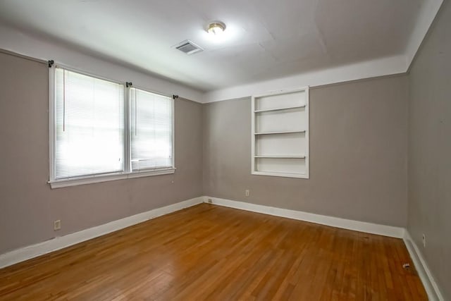 157 Gruner Rd, Metairie, LA 70001 - unfurnished room featuring built in shelves and wood finished floors